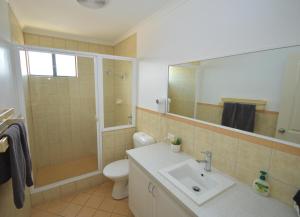 a bathroom with a toilet and a sink and a shower at Blue Ocean Villa 7 - Kalbarri, WA in Kalbarri