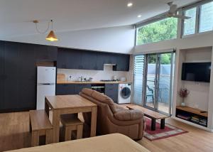 a kitchen with a couch and a table in a room at Studio Apartment close to the CBD in Unley
