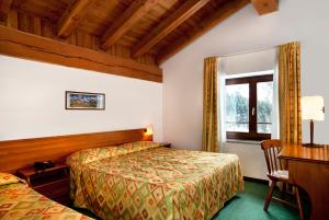 Postel nebo postele na pokoji v ubytování Hotel Beau Site