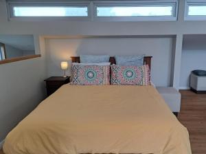 a bedroom with a large bed with two pillows at Studio Apartment close to the CBD in Unley
