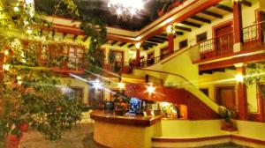 a building with a staircase in the middle of a room at Hotel Real del Valle in San Cristóbal de Las Casas