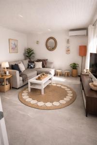 a living room with a couch and a coffee table at garden home in Gaios