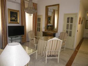 a living room with a table and chairs and a television at Atocha Palace in Madrid