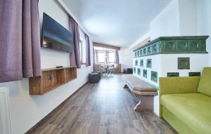 a living room with a couch and a flat screen tv at Holiday Lodge Fabian in Saalbach Hinterglemm