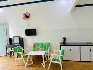 a room with two chairs and a table and a counter at Hotel 86 in Phan Thiet