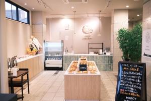 a bakery with donuts on display in a store at Hotel Elite Kyoto Station in Kyoto