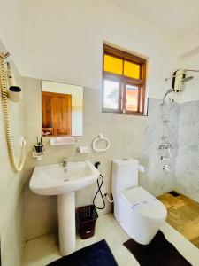 a white bathroom with a sink and a toilet at Zentara Hills in Haputale +31 photos
