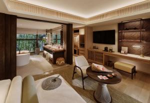 a living room with a couch and a bathroom at Lagen Island Resort El Nido in El Nido