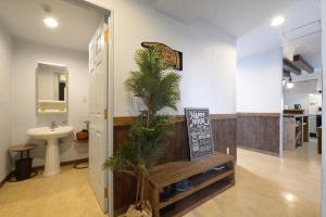 a bathroom with a sink and a palm tree at Sea Side TOYA in Yomitan +106 photos
