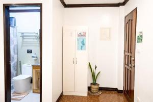 two images of a bathroom with a toilet and a sink at PEPAYEN Homestay in General Luna +44 photos