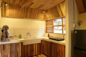 a kitchen with wooden cabinets and a sink and a window at Yugen Village in Khu Chi Lăng +34 photos