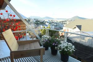 a balcony with a bench and some flowers on it at Yugen Village in Khu Chi Lăng