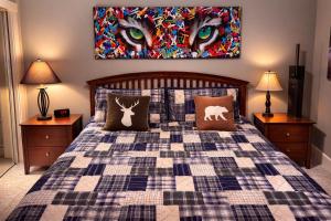 a bedroom with a bed with a checkered blanket at Summit View Alpine Retreat in Radium Hot Springs