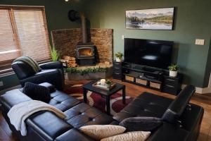 a living room with a couch and a fireplace at Summit View Alpine Retreat in Radium Hot Springs