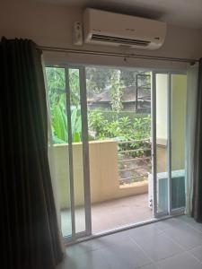 an open sliding glass door with a view of a garden at Aonang Cozy VIP in Ao Nang  +27 photos