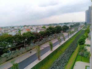 an empty street with trees and a city in the background at GÂY THƯƠNG NHỚ Homestay Phòng trong vinhome grand park tên cũ I love vinhome grand park in Gò Công +155 photos