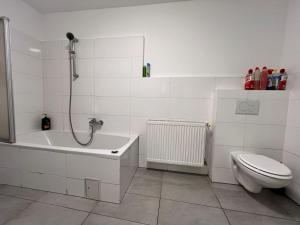 a bathroom with a shower and a toilet and a sink at Brilliant Souterrain Apt - Prter Amuesement Park in Vienna