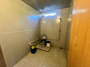 a bathroom with a toilet and a trash can at Ohlala Guesthouse in Perhentian Islands