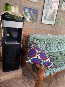 a trash can next to a couch with a pillow at Paje Haven in Paje