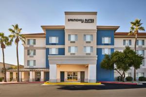a hotel with palm trees in front of it at SpringHill Suites Phoenix Glendale/Peoria in Peoria