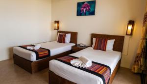 a hotel room with two beds at Kata Silver Sand in Kata Beach +29 photos