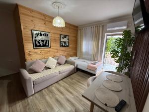a living room with a couch and a table at villa Heljos apartaments in Vlorë