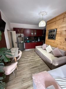 a living room with a couch and a table at villa Heljos apartaments in Vlorë