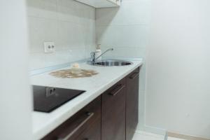 a bathroom with a sink and a counter at Koncept RK in Banja Luka