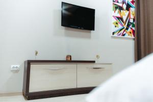 a living room with a tv on a white wall at Koncept RK in Banja Luka
