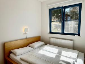 a bedroom with a bed and a window at Ein Haus am Berg in Marquartstein