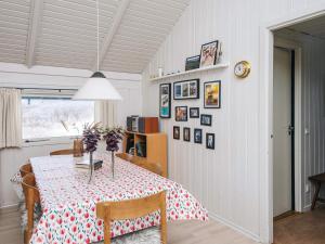 a dining room with a table and some pictures on the wall at 4 star holiday home in Vejers Strand in Vejers Strand