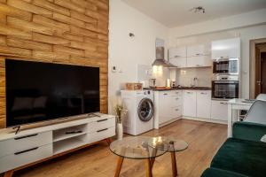 a living room with a large flat screen tv at Relax & Luxury apartment in Veľká Lomnica