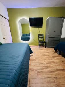 a bedroom with a bed and a mirror and a tv at Departamento Mateo'S 505 in Ciudad Acuña