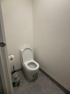 a bathroom with a white toilet in a stall at Peaceful Room in Wyndham Vale for Stay in Wyndham Vale