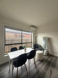 a living room with a table and chairs and a window at Peaceful Room in Wyndham Vale for Stay in Wyndham Vale