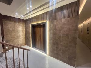 a hallway with a staircase and a door in a building at Hotel Luxe in Kānpur