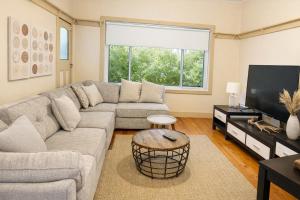 a living room with a couch and a flat screen tv at D103 Lemon Tree House in Melbourne