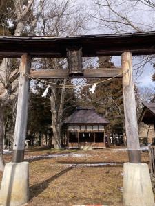 a wooden structure with a building in the background at 民泊ひなたぼっこ1日1組限定離れ貸切 in Nagano