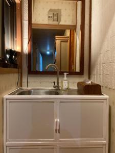 a sink in a kitchen with a mirror above it at 民泊ひなたぼっこ1日1組限定離れ貸切 in Nagano +21 photos