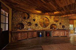a room with a stone wall with wooden cabinets at Puluong Qui E Ora in Lũng Tiềm