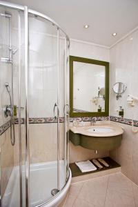 a bathroom with a shower and a sink and a tub at Vip's Motel Luxury Accommodation & Spa in Lonato del Garda