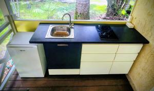 a small kitchen with a sink and a window at EVASION Bungalow Harmonie in Sarraméa +10 photos