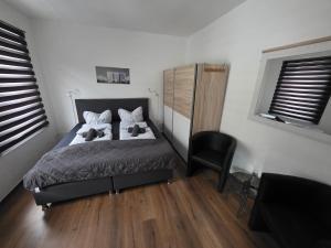 a bedroom with a bed with two teddy bears on it at Gästehaus Strandbake in Cuxhaven