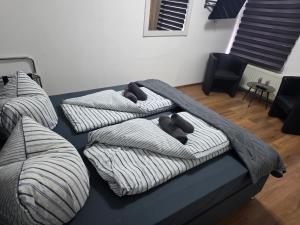 a bed with three pillows with teddy bears on it at Gästehaus Strandbake in Cuxhaven