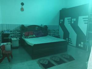 a bedroom with a bed in a blue room at VIPIN homestay in Bāghpat