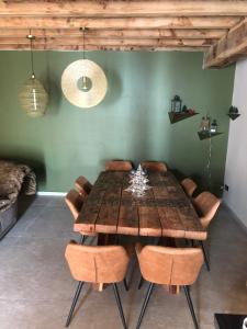 a dining room with a wooden table and chairs at Forest d' ARTO in Ancelle
