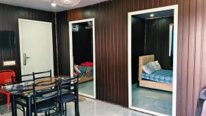 a dining room with a table and chairs and a bedroom at Amigos rooms in Annavaram