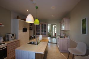 a kitchen with a sink and a counter top at Virulase Holiday Home in Toila