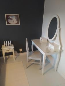 a white dressing table with a mirror and a chair at Villa Alice room 2 in Tampere