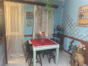 a small table with a vase of flowers on it at Home Room in San Pietro Avellana